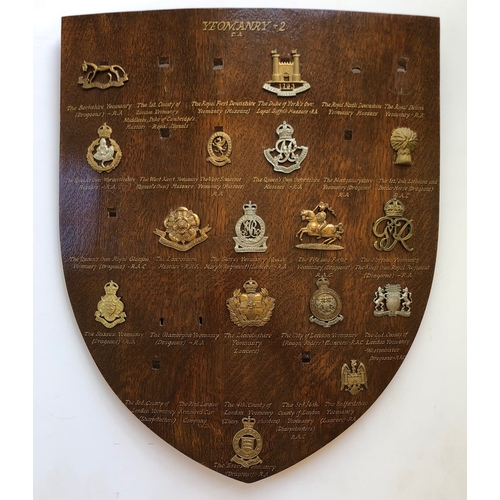 102 - 16 Yeomanry cap badges mounted on shield.   Good selection beautifully mounted on varnished wooden s... 