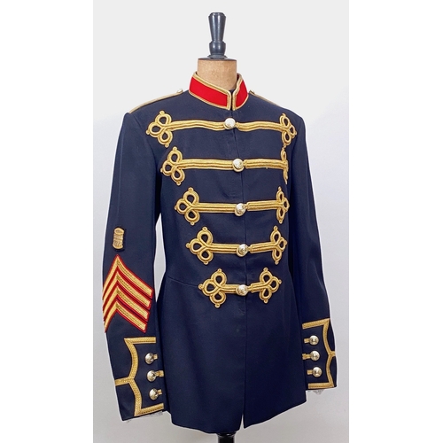 Royal Marines Band Drum Major Tunic.   A scarce Elizabeth II period example, dark blue wool cloth, decorated with five loops of bullion cords to each breast, terminating with a Corps pattern anodised button. Complete with gold bullion rank insignia to the left sleeve. Interior with lining and issue label. Bullion remains fresh. GC.