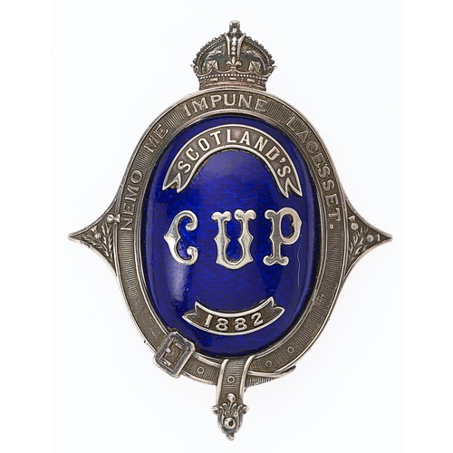 1882 Scotland Cup shooting prize award.   A magnificent large badge comprising a crowned oval silver NEMO ME IMPUNE LACESSET strap with rich Royal blue domed translucent enamel centre mounted with silver SCOTLAND  CUP 1882. Stout hinged pin to reverse which is engraved G. HERBERT 1st K. A.V. Minor restoration to reverse otherwise VGC.            The 1882 competition, held annually at Montrose Rife Gathering in August, was won by 1st Kincardineshire Artillery Volunteer Corps.
