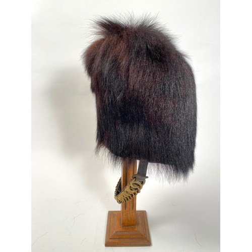 Scots Guards Other Rank's Bearskin. A good example of unusual small proportions, possibly used by a Drummer or Bugle Boy. There appears to be no provision for plume on either side. Complete with graduated brass, leather backed chin chain. Leather lining and wicker frame to the interior. GC little service and age wear. Good shape.