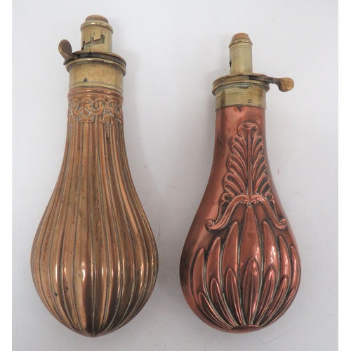 Copper and Brass Fluted Design Powder Flask
bag shape body with fluted design.  Brass top with marked "Improved Patent".  Adjustable nozzle.  Together with a copper bodied bag flask with floral design.  Brass top with adjustable nozzle.  Both springs absent.  