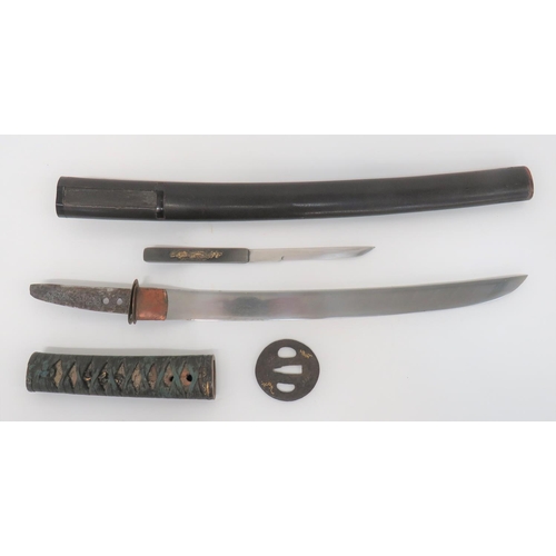 Japanese Unsigned Tang Wakizashi Short Sword
14 inch, single edged, polished blade.  Short double hole unsigned tang.  Copper habaki.  Steel tsuba with gilt swirl decoration.  Darkened fuchi and kabuto gane with silver and gilt decoration.  White shagreen grip with blue cord binding holding the darkened and gilt menuki in place.  Contained in its black lacquered scabbard, complete with small kozuka knife with darkened copper hilt and gilt dragon decoration.  