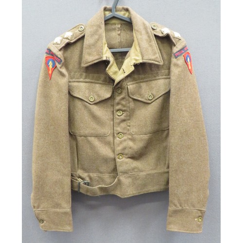 1940 Pattern Royal Marines Officer's Battledress Jacket
khaki woollen, single breasted, closed collar, short jacket.  Lower belt with parkerised buckle.  Patch chest pockets with buttoned flaps.  Both arms with bevo weave Royal Marine titles over embroidery Royal Marines Training Centre formation.  Shoulder straps with embroidery Lieutenant rank stars.  Internal maker's label dated 1944. 