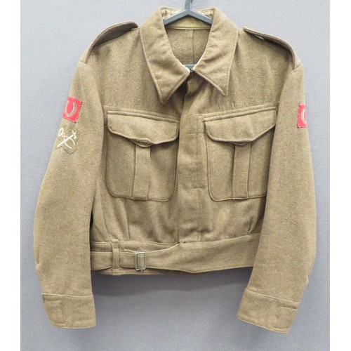 1937 Pattern 13th Division Battledress Jacket
khaki woollen, single breasted, closed collar, short jacket. Lower belt with plated buckle.  Pleated chest pockets with buttoned flaps.  Both arms with printed 13th Division formation.  The right arm with embroidery Armourer trade badge.  Internal maker's label with faint date 1941. 