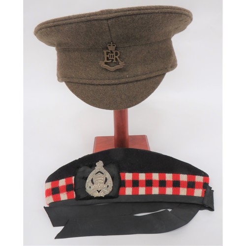 Scottish Glengarry
dark blue body with lower red, white and black checkered band.  Black silk tails and badge backing.  White metal Essex and Kent Scottish badge.  Together with a post war, khaki woollen, Other Ranks service dress cap.  Brass, QC Military Provost Staff Corps badge ... Records and Badges Of The British Army book printed 1895.  Some damage.  3 items.