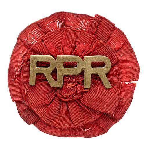 South Africa. Railway Pioneeer Regiment Boer War sheet brass slouch hat badge.  Good rare RPR letters on red silk rosette. Wire loops. VGC        Raised 1899 used on military police duties. Disbanded 1902