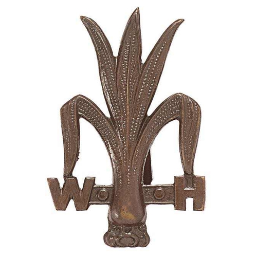 Welsh Horse WW1 OSD field service cap badge circa 1914-17.   Fine rare short-lived die-cast bronze Leek flanked by W and H    Blades.  VGC  Raised August 1914 and amalgamated with Montgomeryshire Yeomanry in 1917.