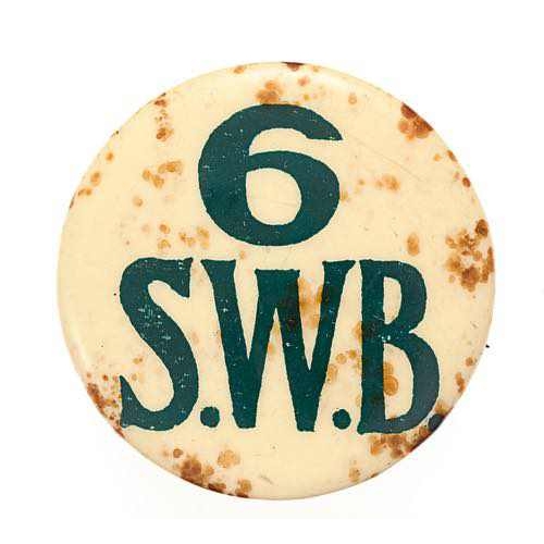 368 - Welsh. 6th (Service) Bn. South Wales Borderers SWB early WW1 badge.  Good rare circular off white ce... 