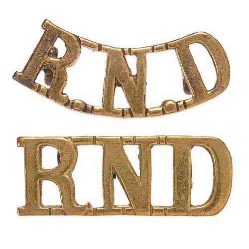 Royal Naval Division 2 x RND shoulder title badges.  Good scarce cast brass examples, one straight, the other curved. (2 items)    Loops.  VGC