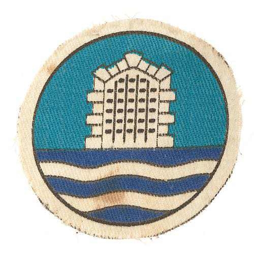 398 - 101st Coast Artillery Brigade printed cloth formation sign badge.  White gateway and waves on white ... 