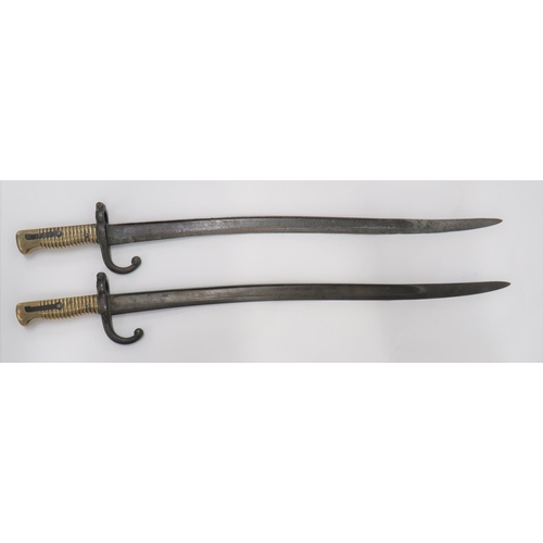 Two French Chassepot Bayonets
22 1/2 inch, single edged, yataghan blades with large fullers.  Back edges with faint maker details.  Steel  hook quillon and muzzle ring.  Brass ribbed grip.  Some pitting to steel.  2 items.