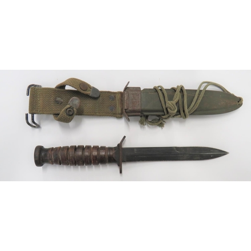 American M3 Combat Trench Knife by Camillus
6 3/4 inch, single edged blade with back edge sharpened point.  Blackened steel crossguard marked "US. M3. Camillus".  Blackened steel, oval crossguard stamped with flaming grenade.  Leather washer ribbed grip.  Contained in its green fibre scabbard with steel throat stamped "US. M8. BM Co."  Green webbing belt loop. 