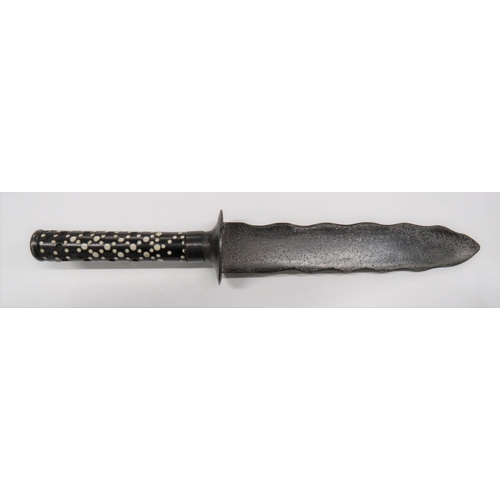 19th Century Wavy Blade Knife
7 3/4 inch, double edged, wavy blade.  Steel disk crossguard.  Brass ferrule.  Blackened wood grip with bone dot decoration (some absent).  