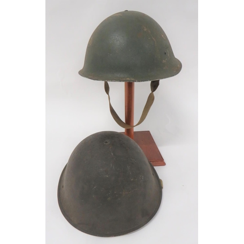 WW2 D-Day Pattern Steel Helmet
dark green, rough texture crown.  Black treated linen liner with fibre cruciform dated 1944 and second pattern cruciform rubber crown pad.  Elasticated chinstrap.  Together with a later pattern helmet with black treated linen liner on quick release cruciform band.  Elasticated chinstrap.  Some minor damage to one liner.  2 items.
