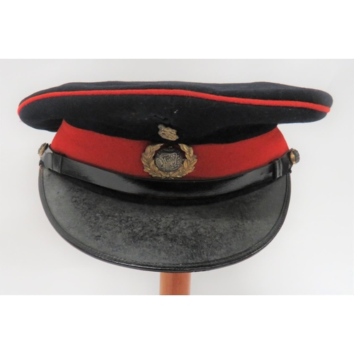 Post 1901 Royal Marines Officer's Dress Cap
dark blue crown and body with red piping and lower band.  Black patent leather peak and chinstrap secured by silvered and gilt, KC regimental buttons.  Silvered and gilt, two part, KC Royal Marines badge.  Leather sweatband.  Silk lining with "Gieves Ltd" tailor's label.  Minor moth nips.  