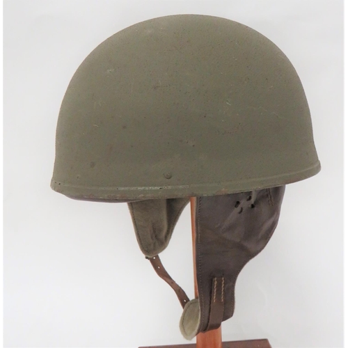 1944 Dated Dispatch Rider's Steel Helmet
green painted, rough texture, dome crown.  Inner cloth fibre padding.  Leather crown pad with ear flaps and laced neck flap.  Leather and webbing head harness marked with maker "BMB" dated 1944.  Clean example.  