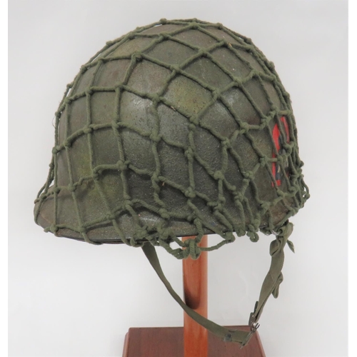 312 - Post November 1944 American M1 Helmet
dark green, rough texture shell with spray areas of light gree... 