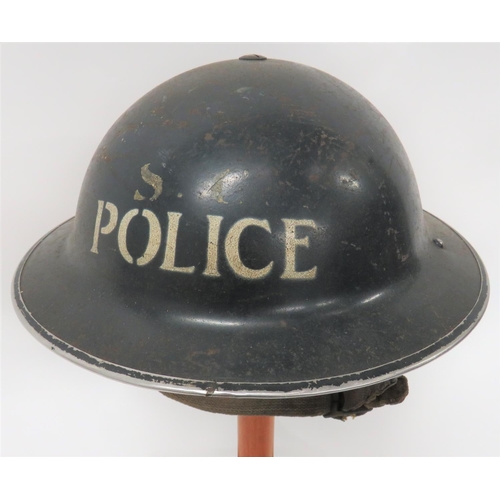 1939 Dated Police Special Constabulary MKII Steel Helmet
dark blue painted outer shell.  The front with white stencilled "SC" over "Police".  Inner brim dated 1939.  Black treated linen liner.  Fibre frame by "Helmets Ltd" dated 1939.  Rubber, circular crown pad.  Sprung side webbing chinstrap.  