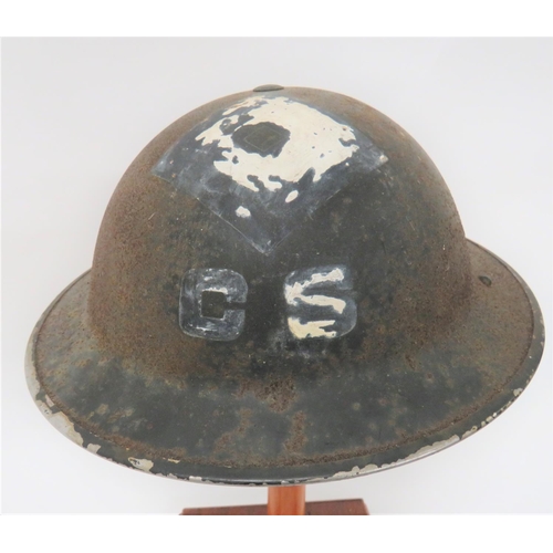 WW2 Divisional "C.S" Officer MKII Steel Helmet
black painted outer shell with white painted 'CS" surmounted by a large diamond to the front and "CS" to the rear.  Black treated linen liner.  Rubber cruciform crown pad.  Sprung sided webbing chinstrap.  Helmet has been stored in a damp place with rusting to the crown and damage to the liner.  