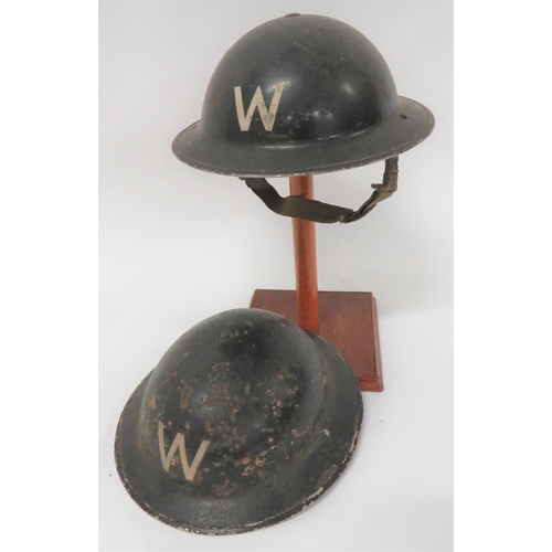 Two WW2 Warden MKII Steel Helmets
consisting black painted outer shell with white painted "W" to the front and rear.  Khaki painted inner brim dated 1939. Black treated linen liner.  The fibre frame with rubber cruciform crown pad.  Sprung sided webbing chinstrap.  Together with a similar example.  Traces of crown bar overpainted.  Inner brim dated 1939.  Black treated linen liner.  The fibre frame with maker "Helmets Ltd" dated 1939.  Rubber, circular crown pad.  Chinstrap broken.  2 items 