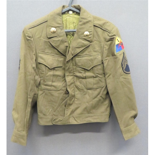 1944 Dated American 1st Armoured Field Jacket
khaki, single breasted, open collar, short jacket.  Pleated chest pockets with buttoned flaps.  Lower short belt.  Collar with brass US disc and Armoured disc.  Both arms with Sergeant chevrons.  The left arm with Armoured formation badge.  Internal issue label dated 10/44.  Minor wear. 