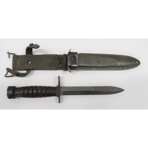 American M4 Knife Bayonet By Aerial
6 1/2 inch, single edged blade with back edge sharpened point.  Grey steel muzzle ring crossguard marked "US M4 Aerial" and flaming grenade.  Oval steel pommel with double locking catch.  Leather washer ribbed grip.  Contained in its green fibre scabbard with steel throat marked "US. M8. B.M Co".  Green webbing belt loop. 