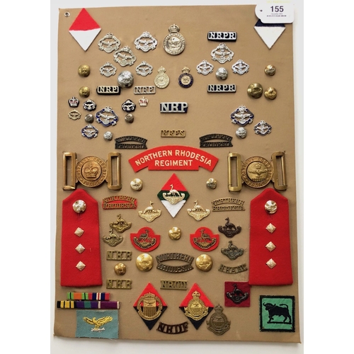 155 - Northern Rhodesian Police and Military 78 items of insignia.  Board with good  display of metal and ... 