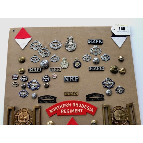 155 - Northern Rhodesian Police and Military 78 items of insignia.  Board with good  display of metal and ... 