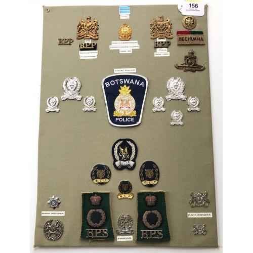 156 - Bechuanaland and Botswana Police and Military 28 items of insignia.  Board with good tabulated displ... 