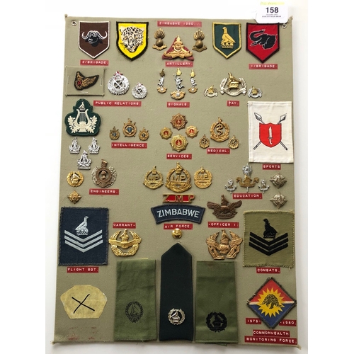 158 - Zimbabwe Army 55 items of insignia post 1980.  Board with good tabulated display of metal and cloth ... 