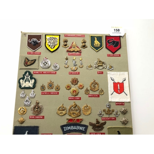 158 - Zimbabwe Army 55 items of insignia post 1980.  Board with good tabulated display of metal and cloth ... 