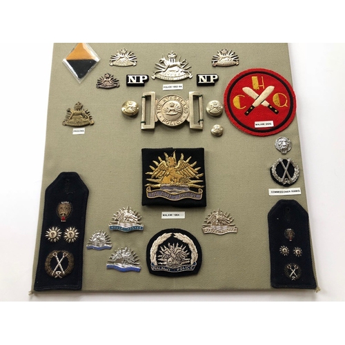 159 - Nyasaland and Malawi Military And Police 36 items of insignia.  Board with good tabulated display of... 