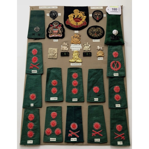 160 - Nyasaland and Malawi Military 28 items of insignia mainly post 1964.  Board with good tabulated disp... 