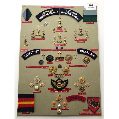 162 - Rhodesian Signals, Chaplains, Army Service Corps 50 items of insignia.  Board with good  display of ... 