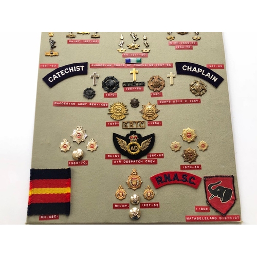 162 - Rhodesian Signals, Chaplains, Army Service Corps 50 items of insignia.  Board with good  display of ... 