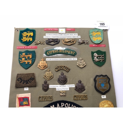 165 - Cyprus Military and Police 47 items of insignia.  Board with good display of metal and cloth badges ... 