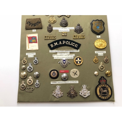 165 - Cyprus Military and Police 47 items of insignia.  Board with good display of metal and cloth badges ... 