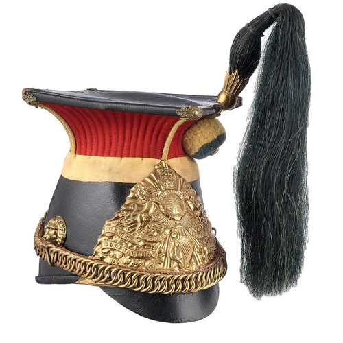 5th Royal Irish Lancers Edwardian lance cap.  A good scarce patent leather body, peak and crown with ornate gilt metal fleur bosses to each corner.  The upper section is of scarlet cloth. Victorian regimental lance plate to front with battle honours. Lion’s head bosses support  brass and leather-backed chin chain. Woollen boss with crowned VR button to centre supports a dark green horsehair plume mounted in gilt metal plume holder.  Leather and waxed cotton lining with issue stamps to the interior for 1902.  Good clean condition. GC