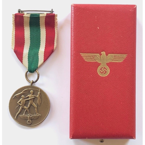 German Third Reich cased Medal for the Return of the Memelland, 22nd March, 1939.  A good scarce bronzed example mounted as worn complete with brooch pin. Housed in red leatherette case bearing golden eagle and swastika to the lid. VGC        Designed by Professor Klein and instituted 1st May 1939 on Hitler’s orders.