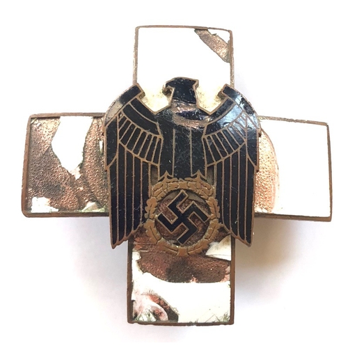 German Third Reich Social Welfare Organization Merit Cross.  A relic 2nd class breast award. White enamel cross with applied black enamel eagle and swastika. Enamel AF. Pin back and securing hook (hinge with later small pin).