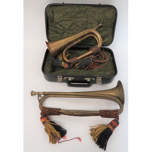 240 - Two Military Pattern Bugles
consisting a Victorian example in brass, complete with mouthpiece.  ... 