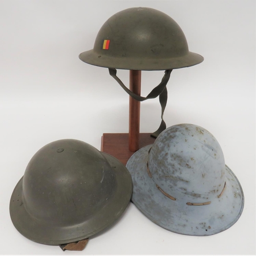 296 - Two MKII Steel Helmets And A Civil Defence Steel Helmet
consisting green repainted helmet.  The... 