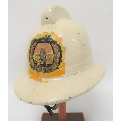Pre 1952 Fire Brigade Helmet
white painted, fabric crown with top comb.  Rounded peak and square back brim.  The front with overlaid wreath and central lion over Kings crown with "FB".  Green linen under brim.  Leather, five tongue liner with maker "Helmets Ltd".  Leather chinstrap.  Paint with minor loss.  
