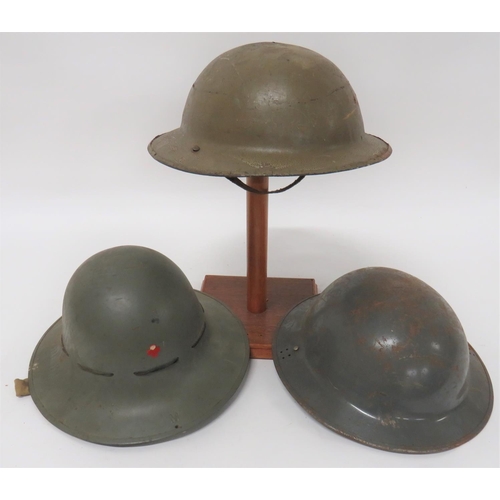 308 - Three Various WW2 Steel Helmets
consisting Civil Defence, grey painted, MKII helmet.  Each side... 