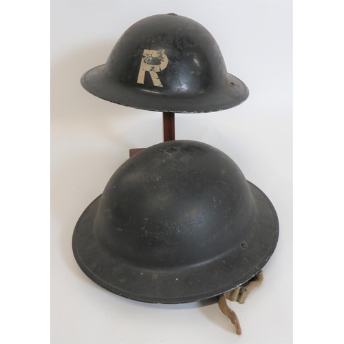 WW2 Rescue MKII Steel Helmet
black painted shell with white R to the front and rear.  Inner brim dated 1943.  Black treated linen liner.  Rubber, oval crown pad.  Together with a similar black painted, MKII helmet.  Black treated linen liner.  Liner frame dated 1939.  Rubber oval crown pad.  Sprung side webbing chin strap.  2 items.