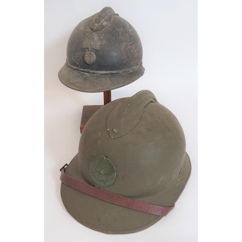 313 - Two French Steel Helmets
consisting M1915 example.  Green painted crown, comb and two piece bri... 