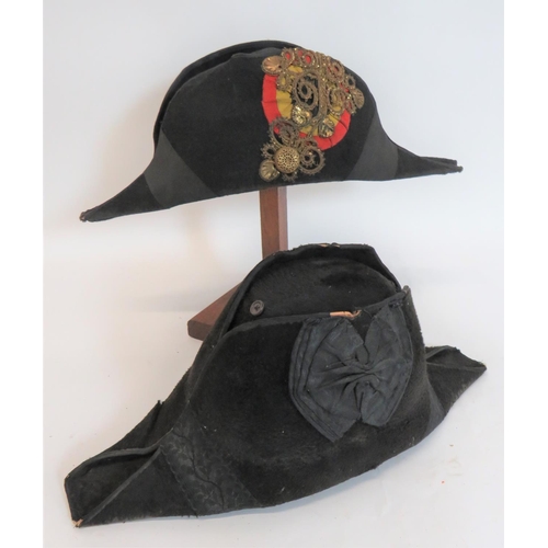 321 - Two Late 19th Century Bicorn Hats
consisting a continental example.  Black sealskin bicorn.  The one... 