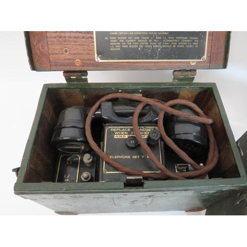 377 - Two WW2 British Field Telephones
green painted, rectangular wooden boxes with reinforced steel corne... 