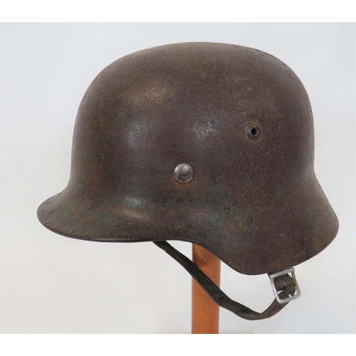 382 - German M1935 Steel Helmet
steel shell with lower rolled edge brim.  Traces of green painted fin... 