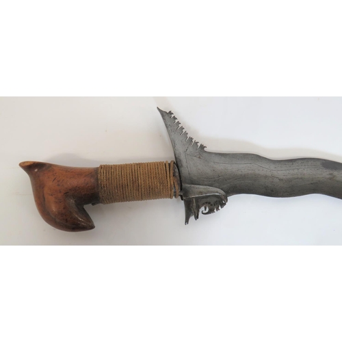 423 - 19th Century Moro Kris
22 inch, wavy edge, wide blade.  Typical flared out forte with chiselled... 